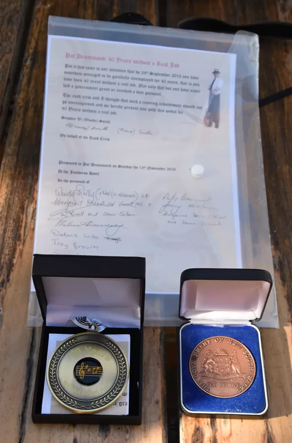 The presentaion address and Woodys own 40 year medal